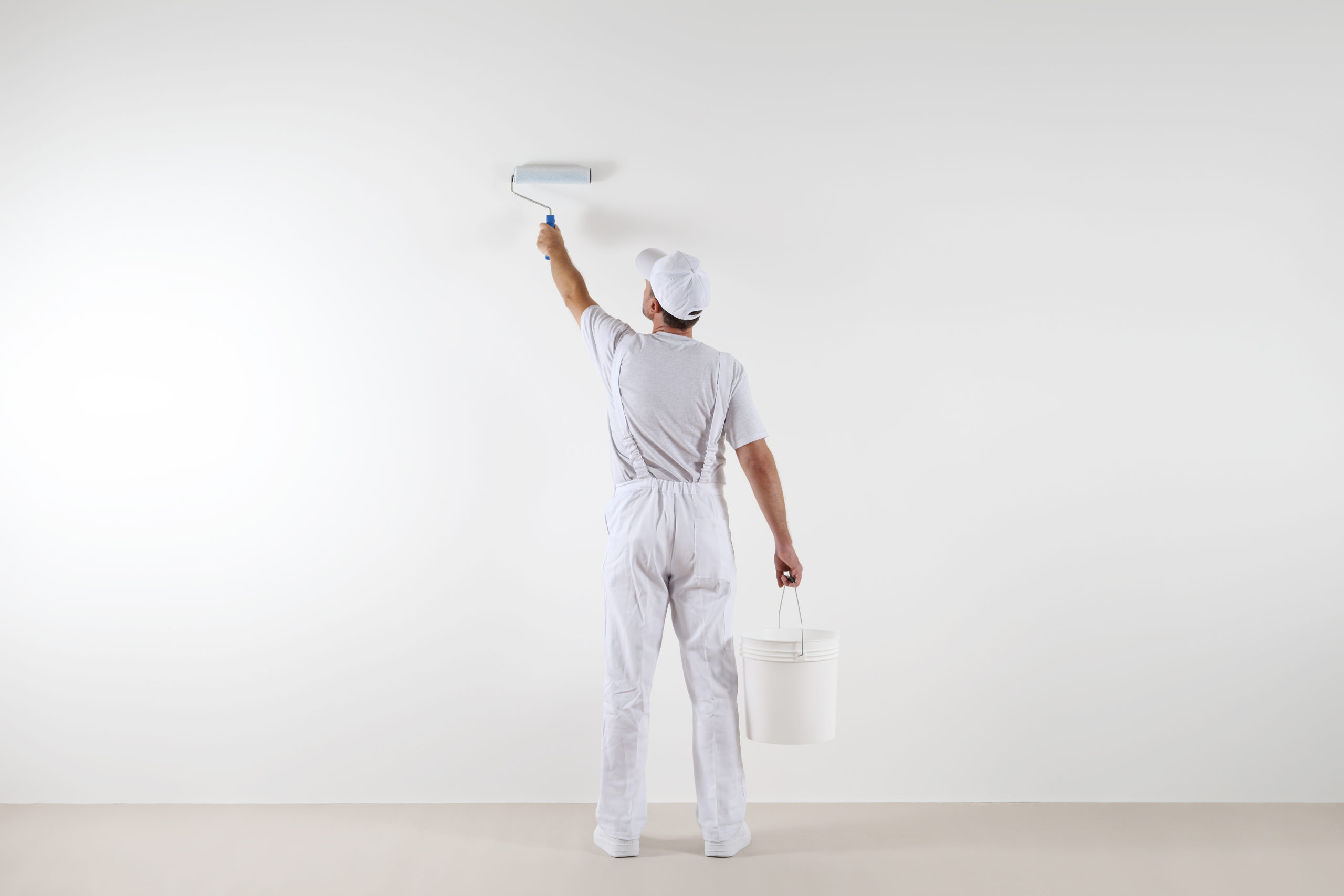 Rear,View,Of,Painter,Man,Painting,The,Wall,,With,Paint